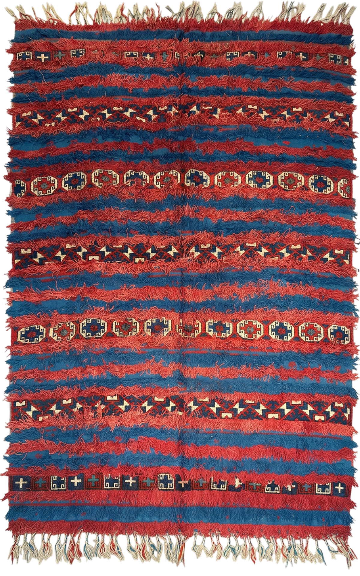 A red and blue hand-knotted rug laid out flat, with fringes along both ends